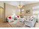 Spacious living room featuring high ceilings, comfortable seating, and plenty of natural light for a cozy ambiance at 6713 E Riverdale St, Mesa, AZ 85215