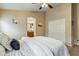 Comfortable bedroom features neutral walls, a ceiling fan, and sliding closet doors at 6713 E Riverdale St, Mesa, AZ 85215