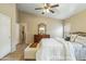 This spacious main bedroom features tile floors, a ceiling fan and closet doors at 6713 E Riverdale St, Mesa, AZ 85215