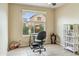 Quiet office features natural light, a desk, and built-in shelving for organization at 6713 E Riverdale St, Mesa, AZ 85215