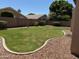 Spacious backyard featuring lush green grass and a well-maintained block fence providing privacy at 6967 W Potter Dr, Glendale, AZ 85308