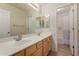 Double vanity bathroom with oak cabinets, tile floors and a shower at 6967 W Potter Dr, Glendale, AZ 85308