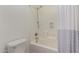 Bright bathroom with tile surround and showerhead and curtain at 6967 W Potter Dr, Glendale, AZ 85308