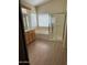 Bright bathroom showcasing a glass-enclosed shower, soaking tub, and a well-lit vanity with natural wood cabinets at 6967 W Potter Dr, Glendale, AZ 85308