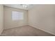 A secondary bedroom has neutral carpet, and natural light at 6967 W Potter Dr, Glendale, AZ 85308