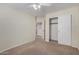 A secondary bedroom with closet space, carpet, and ceiling fan at 6967 W Potter Dr, Glendale, AZ 85308