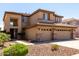 Two story home showcasing a three-car garage, beautiful landscaping, and a charming entrance at 6967 W Potter Dr, Glendale, AZ 85308
