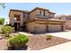 Two story home showcasing a three-car garage, beautiful landscaping, and a charming entrance at 6967 W Potter Dr, Glendale, AZ 85308