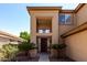View of a home's front entrance, showcasing mature desert landscaping and a balcony feature at 6967 W Potter Dr, Glendale, AZ 85308