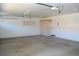 Spacious garage featuring built-in storage cabinets and access door for convenience at 6967 W Potter Dr, Glendale, AZ 85308