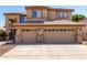 Exterior view of a home featuring a three-car garage with brick accents and neutral color palette at 6967 W Potter Dr, Glendale, AZ 85308