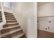 Hallway with carpeted stairs and access to a laundry room at 6967 W Potter Dr, Glendale, AZ 85308