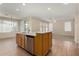 Kitchen island with stainless steel dishwasher and sink, wood cabinets, and tile flooring at 6967 W Potter Dr, Glendale, AZ 85308