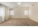 A spacious main bedroom with carpet floors, a ceiling fan, and an ensuite bathroom at 6967 W Potter Dr, Glendale, AZ 85308