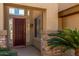 Close up view of a home's entryway, featuring a decorative door and manicured landscaping at 6967 W Potter Dr, Glendale, AZ 85308