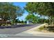 Neighborhood street view with fountain pond and mature trees, showcasing a calm residential community at 6967 W Potter Dr, Glendale, AZ 85308