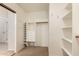 This walk-in closet features shelves, drawers, and wood hanging rails for organization at 6967 W Potter Dr, Glendale, AZ 85308