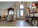 Elegant foyer with tile flooring, arched window and entry door, and ornate console table at 7015 W Behrend Dr, Glendale, AZ 85308