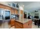 This kitchen boasts a large island with granite countertops and stainless steel refrigerator at 7015 W Behrend Dr, Glendale, AZ 85308