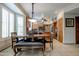 Eat-in kitchen with a beautiful wooden table and chairs near custom wood cabinetry at 7015 W Behrend Dr, Glendale, AZ 85308