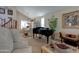 A sophisticated living room featuring a grand piano, comfortable armchairs, and elegant decor at 7015 W Behrend Dr, Glendale, AZ 85308