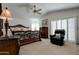 Spacious main bedroom suite with carpeting, ceiling fan, and bright windows at 7015 W Behrend Dr, Glendale, AZ 85308