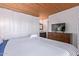 Cozy bedroom featuring wood-style floors, a king-sized bed, and a dresser with a flat-screen TV at 8055 E Thomas Rd # B208, Scottsdale, AZ 85251
