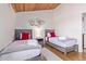 Cozy bedroom showcases vaulted wood ceilings, decor, and two twin beds, offering a relaxing space at 8055 E Thomas Rd # B208, Scottsdale, AZ 85251