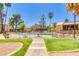 Relaxing community pool surrounded by palm trees and lush landscaping, creating a serene oasis for residents at 8055 E Thomas Rd # B208, Scottsdale, AZ 85251