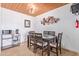 A dining room with modern wooden furniture, a table and chairs, and a unique metal decoration piece on the wall at 8055 E Thomas Rd # B208, Scottsdale, AZ 85251