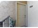 Condo entrance with a textured exterior wall, houseplant, and unit number B208 at 8055 E Thomas Rd # B208, Scottsdale, AZ 85251