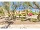 An exterior view of a condo complex, lined with sidewalk, landscaping, and various foliage at 8055 E Thomas Rd # B208, Scottsdale, AZ 85251