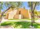 Attractive exterior of a modern, beige-colored home with lush green landscaping at 8055 E Thomas Rd # B208, Scottsdale, AZ 85251