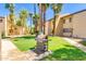 A stainless steel grill on a grassy area surrounded by palm trees and landscaping at 8055 E Thomas Rd # B208, Scottsdale, AZ 85251