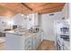 An updated kitchen featuring granite countertops, stainless steel appliances, and a view into the living space at 8055 E Thomas Rd # B208, Scottsdale, AZ 85251