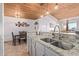 Kitchen view showcasing granite countertops, a stainless steel sink, and sightlines to the dining area at 8055 E Thomas Rd # B208, Scottsdale, AZ 85251
