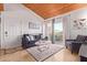 Comfortable living room features a sofa, chair, rug, and access to a balcony at 8055 E Thomas Rd # B208, Scottsdale, AZ 85251