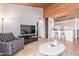 Inviting living room area with a wood vaulted ceiling open to kitchen at 8055 E Thomas Rd # B208, Scottsdale, AZ 85251