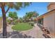 Well-maintained backyard with a neatly manicured lawn, gravel landscaping, and mature trees providing shade at 8443 E Via De Los Libros --, Scottsdale, AZ 85258
