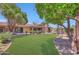 Landscaped backyard featuring lush grass, mature trees, and a patio at 8443 E Via De Los Libros --, Scottsdale, AZ 85258
