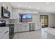 Bright kitchen features modern appliances, white cabinetry, and white tile floors at 8443 E Via De Los Libros --, Scottsdale, AZ 85258