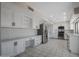 Large kitchen features stainless appliances, white cabinetry, tile flooring, and ample counter space at 8443 E Via De Los Libros --, Scottsdale, AZ 85258