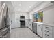 Bright kitchen with white cabinets, modern stainless steel appliances, and neutral countertops at 8443 E Via De Los Libros --, Scottsdale, AZ 85258