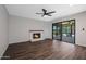 Cozy living room features a painted fireplace, hardwood floors, and a sliding glass door at 8443 E Via De Los Libros --, Scottsdale, AZ 85258