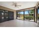 Bright sun room featuring brick accents, ceiling fan, and large sliding glass doors to backyard at 8443 E Via De Los Libros --, Scottsdale, AZ 85258