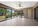 Sun room with floor-to-ceiling glass doors, tan painted floors and brick accent wall at 8443 E Via De Los Libros --, Scottsdale, AZ 85258