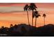 Beautiful sunset view of mountains and silhouetted palm trees in the distance at 8443 E Via De Los Libros --, Scottsdale, AZ 85258