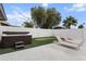 Inviting backyard featuring a hot tub, lounge chairs, putting green, and string lights at 8707 E Clarendon Ave, Scottsdale, AZ 85251