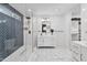 Modern bathroom features white tile, a glass shower, double vanity, and great natural lighting at 8707 E Clarendon Ave, Scottsdale, AZ 85251