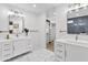 Clean bathroom features white tile, double vanity, and modern fixtures at 8707 E Clarendon Ave, Scottsdale, AZ 85251